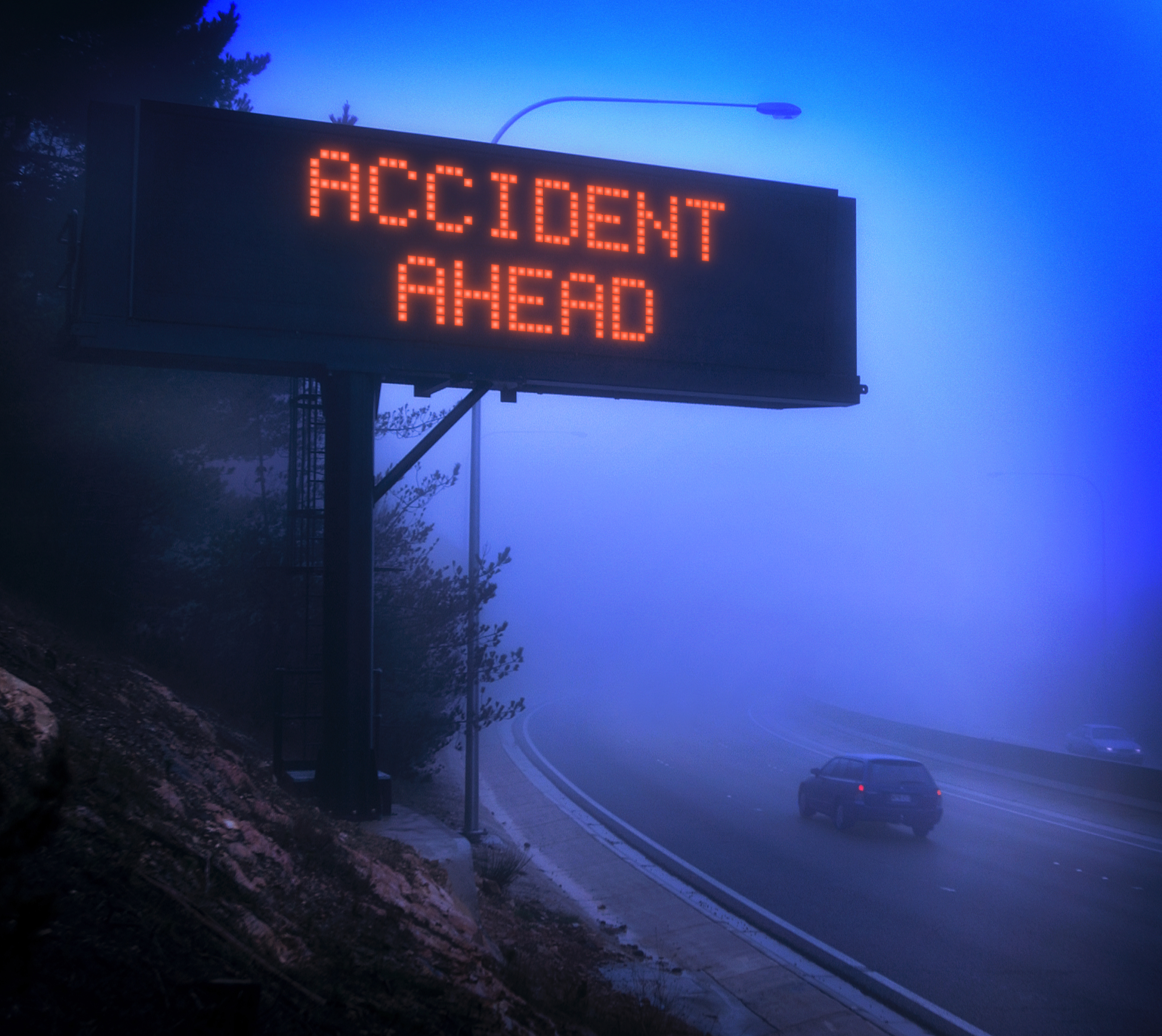 How To Drive In Bad Weather - accident ahead sign foggy mountain road.